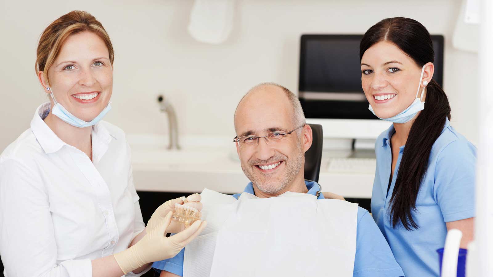 Happy Old patient with Two Dentists